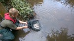 Tim releases the fish into the river